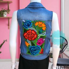 "Mexican floral embroidered vest. Made out of a soft, durable denim, with comfortable stretch. Decorative button-flap faux pockets at chest. Side welt pockets in front. Size- Small Measurements: Bust- 33\" Length- 20\" 🧺Care Instructions: We recommend hand washing separately, hang to dry. 📸Additional photos can be provided upon request. 👗Always allow a little room and consider your own measurements before purchase to avoid any problems. If measurement are exact chances are the garments will b Casual Fitted Vest With Floral Embroidery, Summer Cotton Denim Vest With Floral Embroidery, Casual Embroidered Denim Vest For Summer, Summer Embroidered Blue Denim Vest, Embroidered Blue Denim Vest For Summer, Blue Embroidered Denim Vest For Summer, Casual Embroidered Fitted Denim Vest, Fitted Embroidered Denim Vest Casual, Blue Embroidered Denim Vest