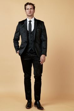 Make party wear easy with this Simon tuxedo style suit. Creating an elegant ensemble for all of those special events, this three piece is made to impress. It features a contrast satin shawl collar and embossed paisley design on the luxurious soft-to-the-touch velvet finish, a real showpiece. Model wears size 38R blazer, 38R waistcoat, 32R trousers. Features Slim fit Single-breasted Shawl lapel Single back vent Four button cuff Single button blazer fastening Waistcoat adjuster straps Complimentar Semi-formal Satin Suits With Notch Lapel, Slim Fit Formal Sets For Winter, Luxury Fitted Satin Set, Satin Tuxedo With Notch Lapel, Classic Fitted Suit For Festive Occasions, Slim Fit Tuxedo Three-piece Suit For Party, Classic Fitted Three-piece Suit For Festive Occasions, Classic Fitted Festive Suits, Fitted Classic Festive Suits