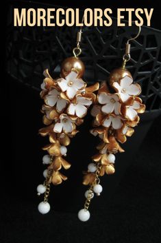 Look at this statement earrings with polymer clay flowers. Original hand made long cluster earrings in older antique look. This unique earrings are made of white polymer clay flowers which are covered golden paint. It will be absolutely perfect for a wedding as an added statement to complete the look in rustic style. May be a great gift for women. #morecolors_Etsy #floral_jewelry #earrings #golden_earrings #gold_and_white #white_gold #wedding #vintage_look #indian_wedding #indian_sari Gold Polymer Clay Jewelry For Wedding, Gold Polymer Clay Wedding Jewelry, Gold Flower-shaped Polymer Clay Earrings, Elegant Bridal Earrings With Handmade Gold Flowers, Elegant Gold Bridal Earrings With Handmade Flowers, Gold Flower Jewelry In Polymer Clay, Gold Flower-shaped Polymer Clay Jewelry, Gold Flower Polymer Clay Jewelry, Gold Jewelry With 3d Flowers In Polymer Clay