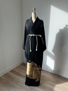 Antique black silk kurotomesode kimono with kasumi (haze) & leaf patterns. White silk lining. Partially embroidered. Kamon (family crest) on the front and back. Shown with silk obijime belt included.  Fits-like: One size fits most Length: 59"  Excellent  *Light marks on the lining.  Dry clean only Black Samurai Kimono With Kimono Sleeves, Elegant Kimono With Kimono Sleeves For Tea Ceremony, Traditional Black Kimono For Tea Ceremony, Ceremonial Long Elegant Kimono, Black Long Kimono For Formal Occasions, Formal Long Black Kimono, Kimono Ideas, Cape Fashion, Embroidered Kimono