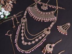 Radiate elegance with our Glimmering Pink Bridal Kundan Necklace, reminiscent of Jodha Akbar's opulence. Paired perfectly with Lehenga or Sari, this Bollywood-inspired piece exudes regal charm. Elevate your bridal ensemble with these Exquisite Wedding Jewels of Unmatched Quality, crafted to captivate and enchant. ❋❋ This set includes - 2 Necklace, 1 Jhumar, 1 pair of Jhumka Earring, 1-piece nose ring, 1 pair bracelet, 1 Maang Tikka ❋❋ ❋❋ Shipping Methods ❋❋ Standard Delivery - Take up to 8-14 bu Heavy Pink Bridal Necklace For Wedding, Bollywood Style Pink Bridal Sets For Wedding, Festive Silver Sets For Marriage, Pink Temple Jewelry Bridal Necklace For Wedding, Pink Bridal Necklace For Wedding On Diwali, Pink Bridal Necklace For Wedding And Diwali, Hand Set Lehenga For Wedding And Diwali, Pink Hand Set Bridal Sets For Reception, Lehenga Sari