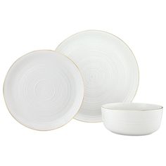 three white dishes with gold rims are shown on a white background and one is empty