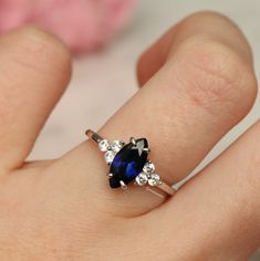 Gorgeous Vintage Inspired Marquise Royal Blue Sapphire Ring ►Made of solid sterling silver with rhodium finish (925) ►Accented With Simulated Diamonds (CZ) ►Average band width: 1.8 mm Center Stone: Sapphire Color: Royal Blue Shape: Marquise Measurements: 4.0 x 8.0 mm Carat Weight: 0.6 ct. (approx.) Gemstone creation: 100% Genuine Lab-Grown Hardness: 9-9.5 (Mohs scale) ►Matching band is sold separately: https://www.etsy.com/listing/932028239/chevron-wedding-band-sterling-silver?ref=shop_home_acti Classic Adjustable Sapphire Ring For Anniversary, Adjustable Classic Sapphire Ring For Anniversary, Classic Adjustable Sapphire Promise Ring, Classic Adjustable Rings With Accent Stones, Classic Sapphire Crystal Promise Ring, Hallmarked Sapphire Birthstone Promise Ring, Sapphire Birthstone Hallmarked Promise Ring, Royal Blue Sapphire Ring, Sapphire Promise Rings