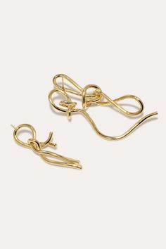 Gold vermeil twisted energetically in this elegant earrings. Secured with an earring post and butterfly back. Elegant Yellow Gold Wrap Earrings For Party, Elegant Twisted Earrings For Pierced Ears, Elegant Twisted Yellow Gold Earrings, Gold Earrings With A Modern Twist, Elegant Twisted Gold Jewelry, Gold Single Wrap Earring For Evening, Elegant Gold Wrap Earrings For Evening, Twisted Gold Plated Earrings For Gift, Single Gold Earring With A Modern Twist