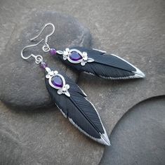 These statement black raven feathers earrings are hand-sculpted of polymer clay and decorated with amethysts gems. Elegant, lightweight and comfortable to wear, they will for sure bring attention to their owner's neckline. Can be a great gift for the raven lover or just a part of Gothic, witchy or Halloween outfit. Perfect match to the raven necklace: https://www.etsy.com/listing/1272180892 Earring length about 3 inches (from the top of the earwire) Drop length 2 1/3 inches Earring width 2/3 inc Crow Feather Earrings, Raven Inspired Outfits, Raven Earrings, Raven Feathers, Feathers Earrings, Blue Nile Jewelry, Raven Feather, Raven Jewelry, Raven Necklace