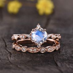 a close up of a ring with a blue stone in the center and diamonds around it