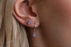 ✨This Flower Huggie Hoop Earring Set features dainty purple earrings, perfect for everyday ear stacks and designed as an elegant gift set of sterling silver jewelry tailored for women. This versatile set of earrings can be worn to elevate the look of a minimalist everyday outfit but is also great for any occasion. You will be able to mix and match it in different ways without getting tired of it. :)  ✨PURCHASE INCLUDES:  * 2 Pairs of Earrings (4pcs) ✨Product specifications:  * Material: Sterling silver with Zircon  * Hoops Diameter (inner): 7mm.  * Hoops width: 2mm. *Stud: 4mm. ✨ Packaging and Gifts:  * All pieces of jewellery are packed to be gift-ready in a cute pouch. I will gladly include a gift message. ✨Shipping:  * All orders will be shipped out within 1 business day by Royal Mail t Purple Dangle Hoop Earrings, Dainty Purple Earrings With Ear Wire, Purple Dainty Earrings With Ear Wire, Everyday Purple Dangle Earrings, Everyday Hypoallergenic Purple Earrings, Purple Dangle Hoop Earrings As Gift, Dainty Purple Nickel-free Earrings, Purple Minimalist Earrings For Pierced Ears, Dainty Nickel-free Purple Earrings