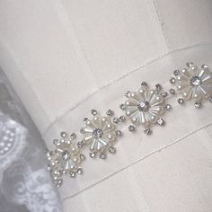 ❤100% handmade, satin rolled roses, suit for bouquet, flower girl basket, wedding deocors ❤ This listing is for 1 meter Measurements: pearl flower: Width- 1.2 inches (widest part of the flower) This sash is made with high quality rhinestones and pearls. A heirloom piece that will add a touch of glamour to any dress. Satin Bridal Belt With Ribbon For Wedding, Elegant Bridal Belt With Flower Decoration, Elegant Bridal Belt With Flower Decoration For Wedding, Elegant Handmade Flower Sashes For Party, Elegant Sashes With Handmade Flowers For Party, Elegant Bridal Belt With Handmade Flowers For Weddings, Elegant Bridal Belt With Handmade Flowers, Pearl Belt, Bridesmaid Sash