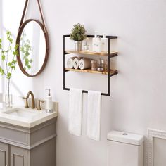 a bathroom with a sink, mirror and shelves on the wall next to the toilet