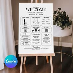 a welcome sign sitting on top of a wooden easel next to a potted plant