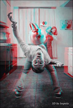 a boy is doing a handstand in the kitchen while another person watches him