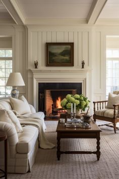 a living room filled with furniture and a fire place next to a painting on the wall