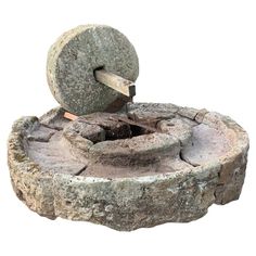 an old stone fire pit with a hammer stuck in it