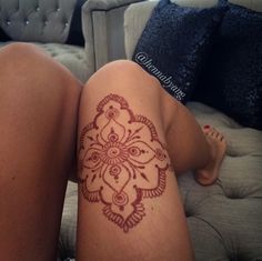 a woman's legs with a tattoo on her leg and the bottom half of her body