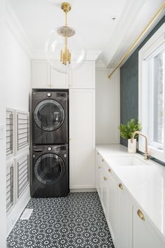 an instagram photo of a washer and dryer in a room with white cabinets