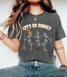 💀Discover our Let's Go Gouls Dancing Skeletons Halloween Comfort Colors tee!💀 This trendy funny Halloween shirt features an eye-catching graphic design that is sure to enhance your next Halloween night! Made of 100% ring-spun ethically grown cotton, this shirt is super soft and comfortable. It has a relaxed fit which is made of a medium fabric that is preshrunk. Looks super cute with shorts or jeans and throw a cardigan on top for that cooler evening. Great gift for a Halloween Lover! Comes in Relaxed Fit Skull Print Top For Halloween, Funny Halloween Tops With Skull Print, Funny Halloween Top With Skull Print, Funny Halloween Skull Print Top, Funny Skull Print Tops For Halloween, Fun Halloween Tops With Skull Print, Fun Halloween Skull Print Tops, Halloween Funny Print Relaxed Fit Tops, Halloween Tops With Funny Print And Relaxed Fit