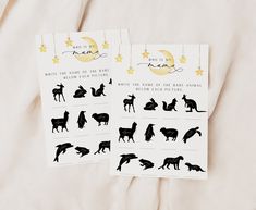 two sheets of paper with animals on them and stars hanging from the strings above them