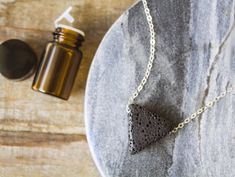 Accessorize with a purpose with our Wellness & Balance Lava Necklaces. Lava stones' porous nature allows it to easily absorb your favorite oil while your body heat contributes to gently diffusing scents to create your very own personal and wearable aromatherapy diffuser! You can even transform your lava experience each day by adding a new fragrance or essential oil. This set includes 1 diffuser necklace and a 2ml bottle of oil. To order, simply select a necklace and type in your choice of an Everyday Spiritual Lava Stone Jewelry, Lava Stone Diffuser, Lava Stone Car Diffuser, Essential Oil Necklace, Oil Bar, Essential Oil Necklace Diffuser, Aromatherapy Diffuser, Diffuser Jewelry, Diffuser Necklace