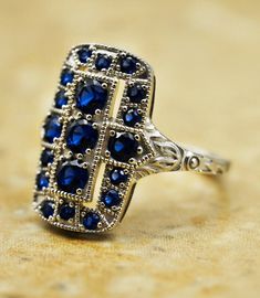 Behold this exquisite vintage ring crafted with care from 925 solid sterling silver! Encrusted with 19 stunning simulated sapphire stones and elegantly anti-tarnish rhodium plated, this beauty is marked with a distinguished stamp of quality - 925. Truly a timeless treasure for your jewelry collection! 🌟