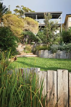 a wooden fence sitting next to a lush green field