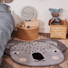 a child's bedroom with teddy bear rugs and other toys on the floor