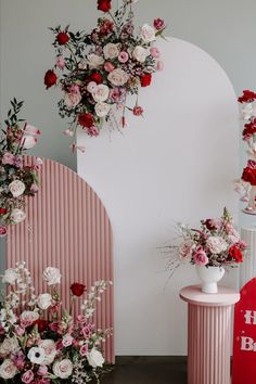 Two modern semi circular backdrops have been decorated with at the top with a flower heavy design filled with red, pink and blush roses. At the base is a meadow style floor based arrangement. Curved Backdrop, Pink Photo Backdrop, Small Wedding Decor, Red Party Decorations, Floral Backdrops, Wedding Church Decor, Pink And Red Flowers, Photo Area