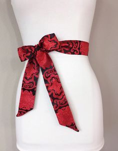 Red & Black Chinese Brocade Sash  Red Sash in Satin Brocade  Red Obi Belt  Black and Red Kimono Sash Belt  Asian Brocade Sash  Satin Swank Elevate your style instantly with this Satin Swank® Asian brocade sash in red and black medallion print.  Sometimes called Chinese brocade, satin brocade, or silk brocade, this is a mid-weight fabric woven into a lustrous, intricate pattern.  This brocade sash is 2 inches wide and 70 inches long, giving most waist sizes the option of tying it in a simple knot Long Open Sweater, Chinese Brocade, Bridesmaid Sash, Red Kimono, Wedding Dress Sash, Medallion Print, Open Sweater, Dress Sash, Obi Belt