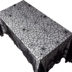 a black and white lace tablecloth with an intricate design on the edge, set against a white background