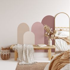 a bedroom with pink and beige walls, white bedding, and a wooden table