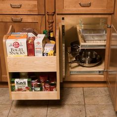 an open cabinet in the middle of a kitchen with spices and condiments on it