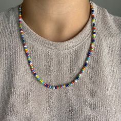 a man wearing a multicolored beaded necklace