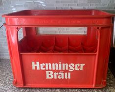 an old fashioned red bin with the word heineiger brau on it's side