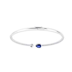 Crafted by our master artisians, this elegant bangle bracelet feature luminous diamonds and a vivid blue sapphire, reminiscent of the free flowling movement of water.\n \n18k white gold. Set with 55 round brilliant-cut diamonds totalling 0.58 carat and 1 pear-shaped sapphire totalling 0.35 carat Birks Splash Sapphire and Diamond Bangle Bracelet, 18k White Gold Blue Sapphire Diamond Bracelet, Birks Jewellery, Sapphire Bangle, Diamond Bangle Bracelet, Blue Sapphire Necklace, Blue Star Sapphire, The Bangles, Jewellery For Women, Diamond Bangles Bracelet