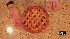 two hands reaching for a pie on a table