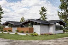 a modern house with three large windows on the roof