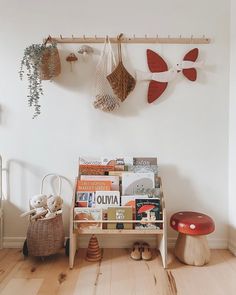 there is a shelf with many books on it in the room next to a mushroom