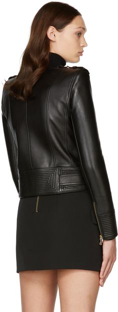 Long sleeve grained lambskin jacket in black. Notched lapel collar featuring press-stud fastening. Offset zip closure at front. Zippered pockets at waist. Buttoned epaulets. Padded shoulders. Zip closure at cuffs. Belt loops at hem. Adjustable belt with pin-buckle fastening at hem. Fully lined. Logo engraved gold-tone hardware. Supplier color: Black Luxury Biker Jacket With Concealed Fastening, Luxury Leather Biker Jacket With Concealed Fastening, Luxury Leather Jacket With Concealed Front Fastening, Luxury Black Leather Jacket With Concealed Fastening, Designer Leather Jacket With Concealed Fastening For Winter, Designer Winter Leather Jacket With Concealed Fastening, Designer Outerwear With Zipper For Work, Chic Formal Leather Jacket With Zipper Closure, Chic Formal Leather Jacket With Zipper