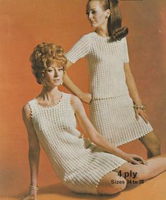 two women in white crocheted dresses sitting next to each other