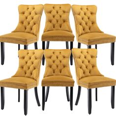 six yellow velvet dining chairs with nail head trimmings on the back and legs