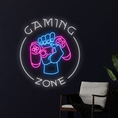 a neon gaming zone sign in the corner of a room with a chair and potted plant