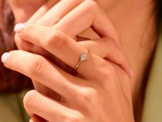 a close up of a person wearing a diamond ring