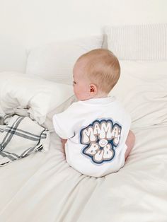 "This sweet set is the perfect combo for bub & mama. The colors are neutral taupes and blue, with coordinating designs. Mama's sweatshirt front reads \"mama\" with a large smile face on the back. The baby sweatshirt is a sweatshirt romper in an oversized fit with \"mama's bub\" on the back with a small smile on the front chest. This baby sweatshirt romper fits large and has snaps for changing time. Makes a beautiful gift for mama & little one in your life. To purchase more than one item, simply Playtime Soft-washed White Tops, White Onesie With Graphic Print For Playtime, White Family Matching Onesie For Playtime, White Cotton Family Matching Onesie, Playful Soft-washed White T-shirt, Playful White Soft-washed T-shirt, Family Matching White Onesie With Graphic Print, Family Matching Graphic Print White Onesie, White Cotton Onesie For Gender Reveal