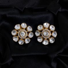 Inspired by Sabyasachi, the Polki Earrings with Kundan Studs feature Uncut Diamond Jadau craftsmanship. These Big India Stud Earrings are a Premium Statement for weddings and Bollywood glamour. They blend traditional elegance with contemporary style, making them a luxurious and meaningful gift for any special occasion. *𝐏𝐑𝐎𝐃𝐔𝐂𝐓 𝐃𝐄𝐓𝐀𝐈𝐋* * Material: Brass * Plating: Gold Plated * Stone: Semi Precious Kundan & Polki *𝐃𝐈𝐌𝐄𝐍𝐒𝐈𝐎𝐍𝐒* * Weight: 8 gm Each, Diameter: 1.1 Inches (Push White Stone Work Earrings For Formal Occasions, Traditional Silver Diamond Earrings For Festive Occasion, Elegant Gota Work Bridal Earrings For Celebration, Formal Silver Cutdana Earrings, Festive Bridal Earrings With Stone Work For Anniversary, Formal Fusion Bridal Earrings With Cutdana, Elegant Silver Jhumkas With Gota Work, Festive Chandbali Bridal Earrings With Rose Cut Diamonds, Traditional White Diamond Earrings