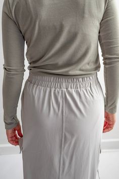 We couldn't help but bring you one more athletic skirt! The Sybil in Shale Gray is a versatile option for everyday wear. A skirt that's both function and feminine - with deep cargo pockets for all the things, an elastic waistband to ensure a comfortable fit, and sides that can be cinched and tied into bows to adjust the length of the skirt - or just for fun! Style: functioning pockets, elastic waistband, cargo-style athletic skirt with side cinch option Color: pale grey Fabric content: 45%Sorona Polyester,36%Recycle Polyester,19%Lycra Care instructions: wash gentle cycle, cold; lay flat to dry, cool iron if needed. For best results, always follow care instructions on garment label. Our sizing is always approximate and can vary due to personal preference and style. For the best experience - Stretch Workout Skirt With Elastic Waistband, Sports Skirt With Stretch And Pockets, Athleisure Skirt With Elastic Stretch Waistband, Stretch Sports Skirt With Pockets, Stretch Skirt With Pockets For Sports, Sporty Flowy Mini Skirt Bottoms, Solid Color Workout Skirt With Elastic Waistband, Stretch Skort With Elastic Waistband, Versatile Skirt With Stretch And Pockets