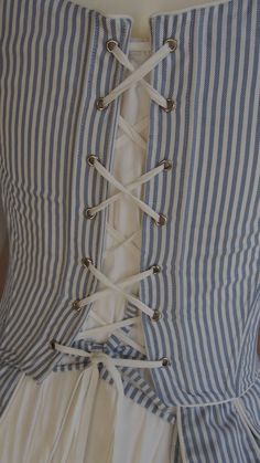 For the 18th century silhouette, I propose a corset to wear on your day shirt. An essential element of any outfit of the 18th century, this corset is made in 2 versions: - Cotton striped white and blue, lined in white cotton. - Cotton white, lined in white cotton White lacing link. Like any corset of the ladies of the bourgeoisie or of the nobility, it is laced only in the back. The servants and peasants only, wore corsets laced at the front, for they had no one to help them dress. Knotted at th Fitted Cotton Corset For Costume, Elegant Cotton Corset With Corset Back, Elegant Cotton Corset With Fitted Bodice, Vintage Fitted Cotton Corset, French Corset, Knot Dress, Corset Lace, French Women, Lace Corset