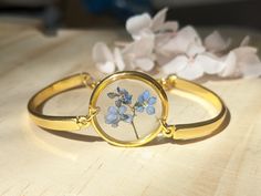 a close up of a bracelet with flowers on it