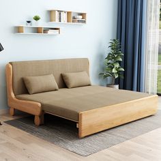 a bed with blue sheets and pillows is in a room next to a book shelf