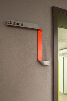 the door is open and there is a sign on the wall that says damen