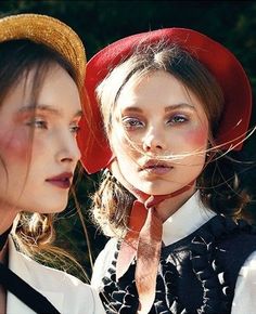 two women wearing hats and ties standing next to each other