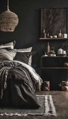 a bedroom with black walls and wooden flooring is pictured in this image, there are baskets hanging above the bed